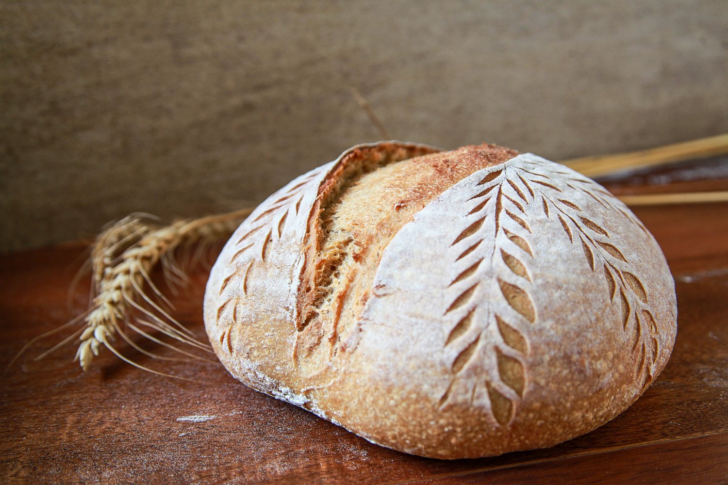 Hearty Khapli Whole Wheat Sourdough loaf with a crisp golden crust and artisanal, rustic finish.