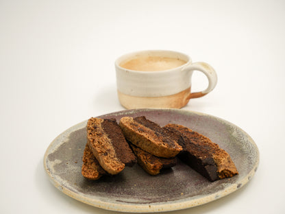 Crisp Coffee Chocolate Cardamom Biscotti in close-up, emphasizing its textured surface and flavorful ingredients.