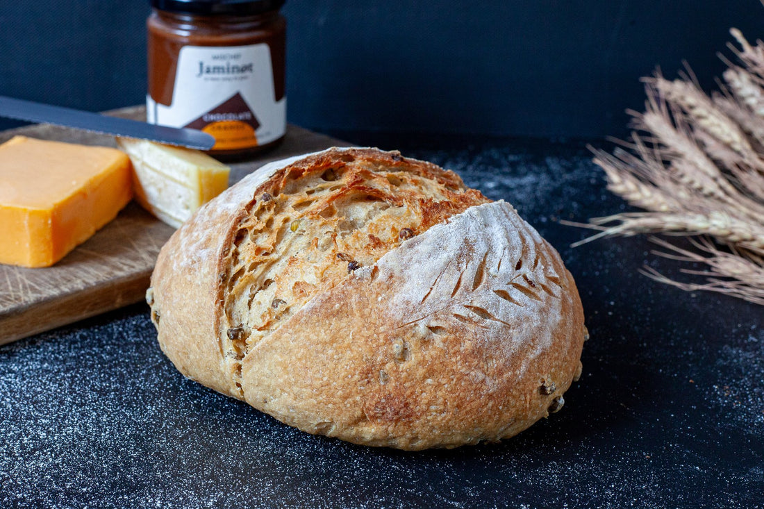 Freshly baked Olive and Rosemary Sourdough bread with a golden crust and aromatic herbs