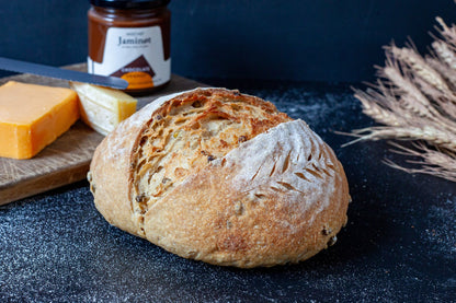 Freshly baked Olive and Rosemary Sourdough bread with a golden crust and aromatic herbs