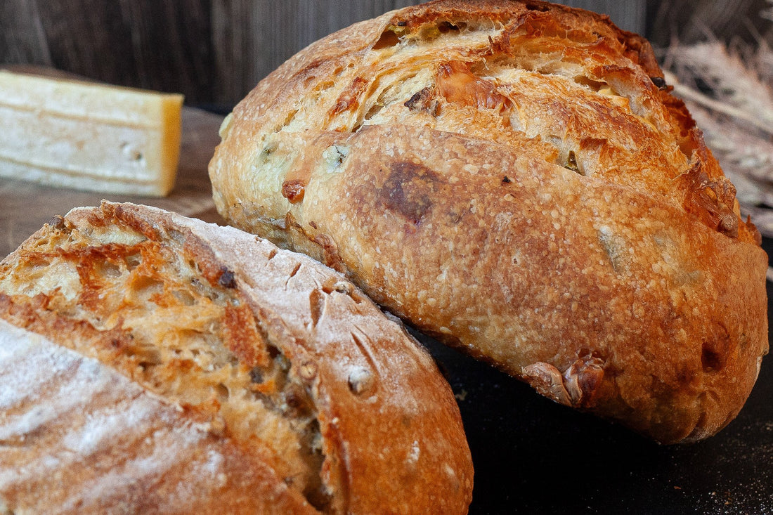 Crusty artisan sourdough loaf with roasted garlic and mixed herbs