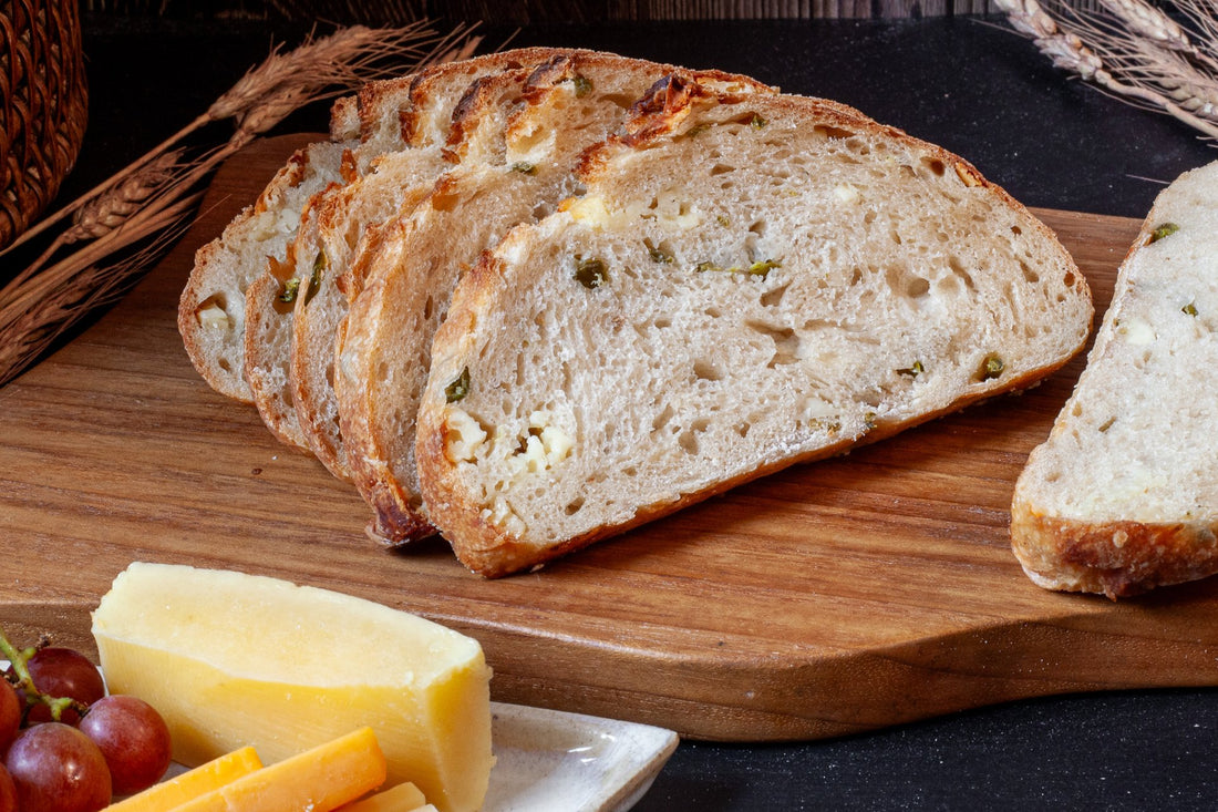 Sliced Jalapeño Cheddar Sourdough showcasing its soft interior and spicy inclusions.