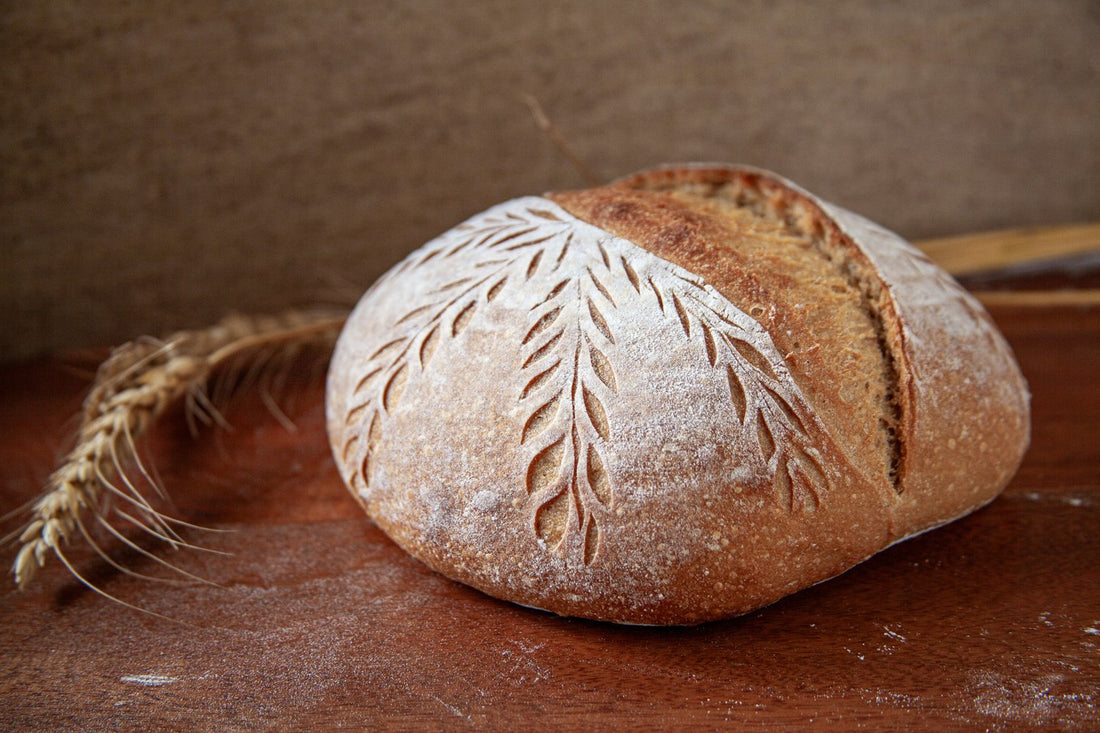 Artisan Whole Wheat Khapli Sourdough loaf with a golden crust and rustic texture
