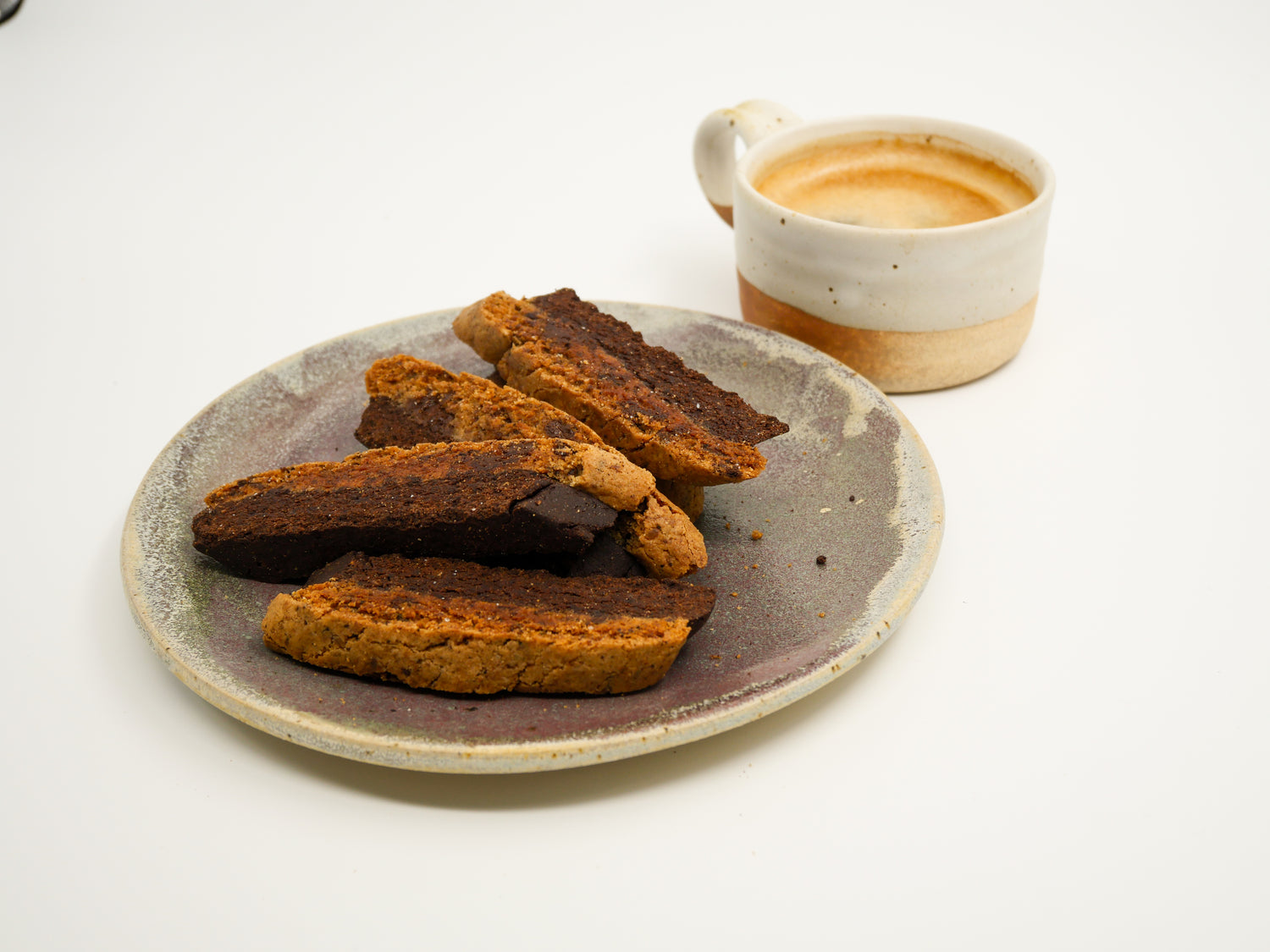 Detailed image of biscotti featuring rich coffee, melted chocolate chunks, and fragrant cardamom spice.